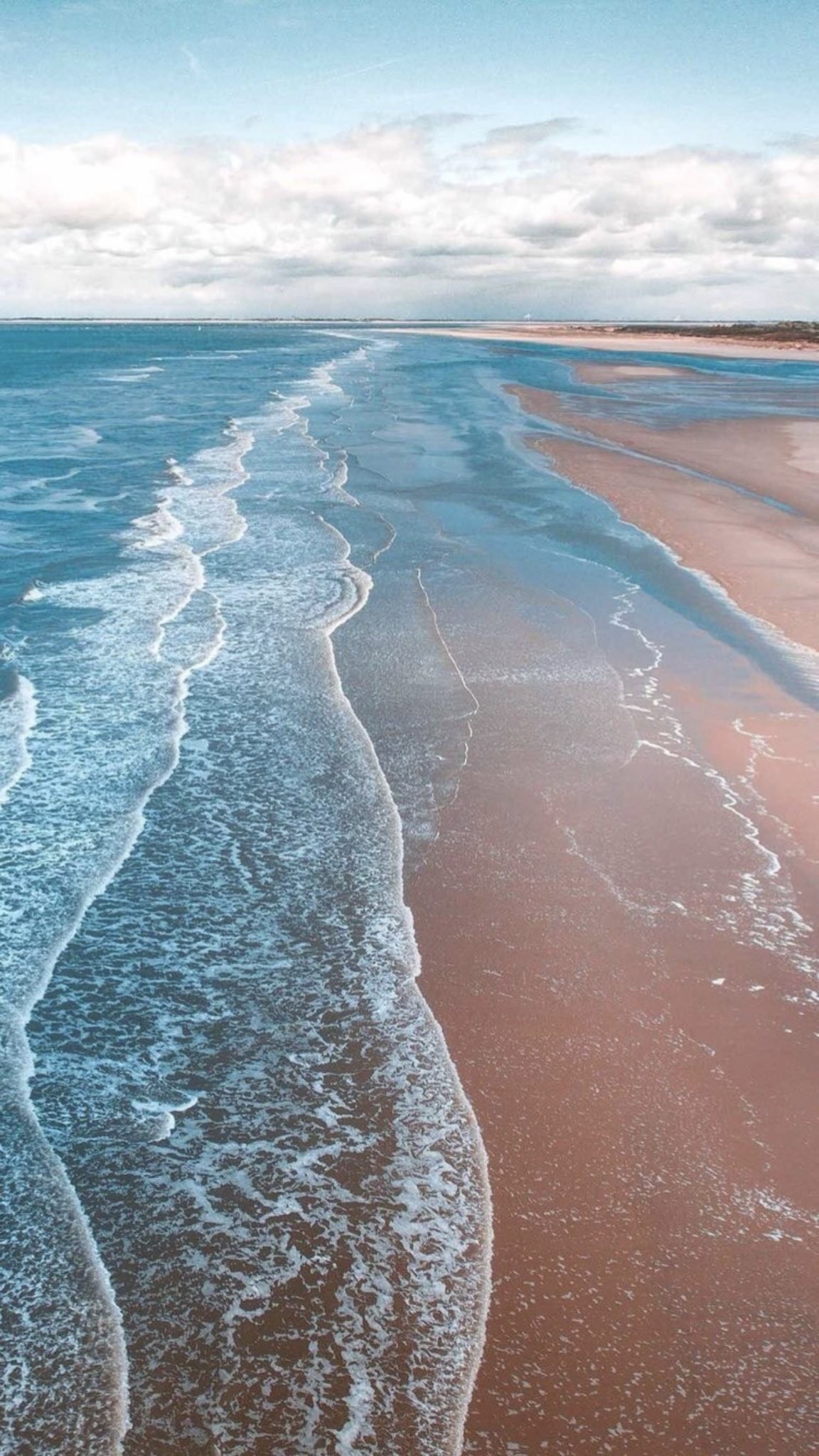 Download Aerial Long Sandy Beach with Turquoise Waves in ultra HD 4K resolution for desktop, iPhone and Android devices.