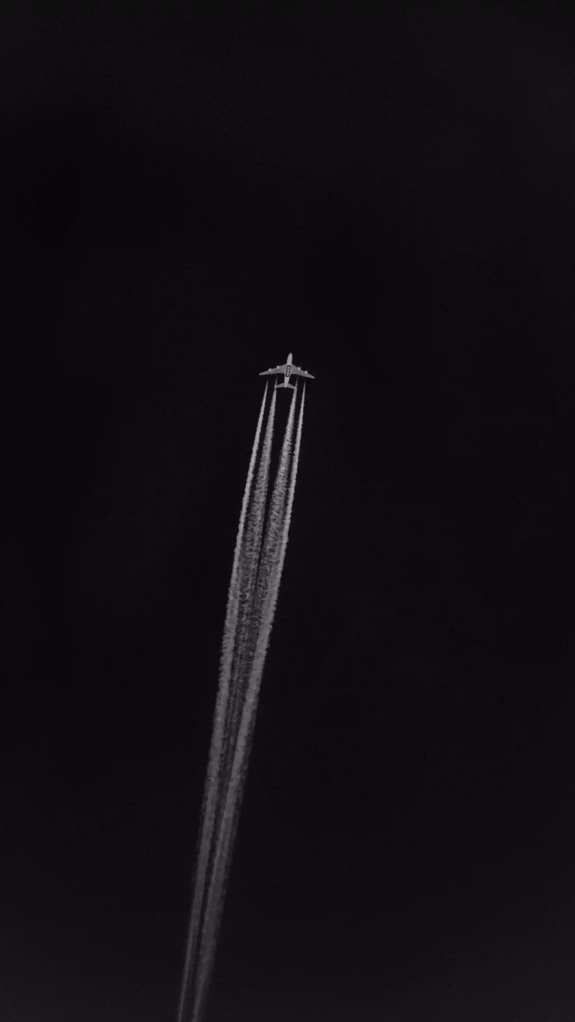 Airplane Contrails in Dark Sky Black and White