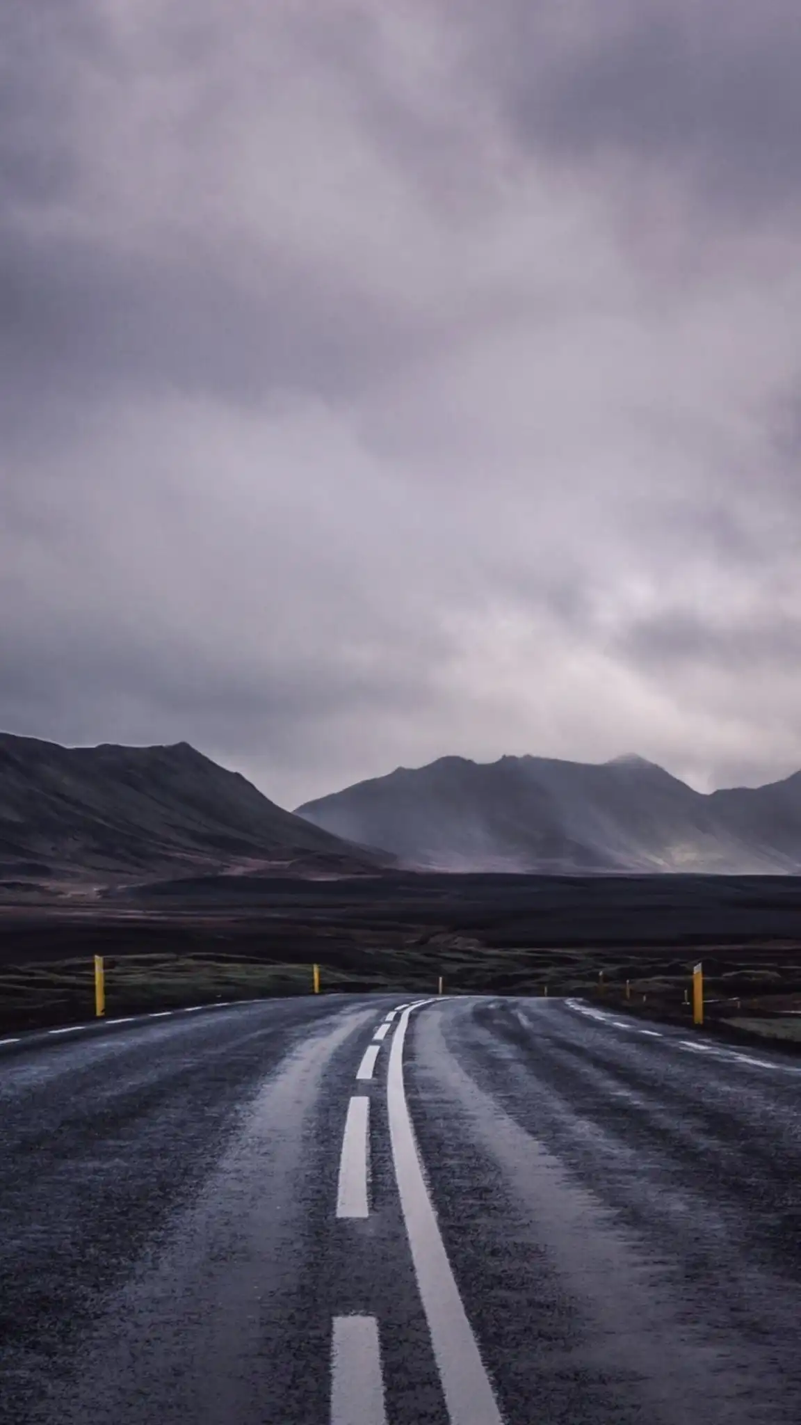 Wet Road Leading to Misty Mountains
